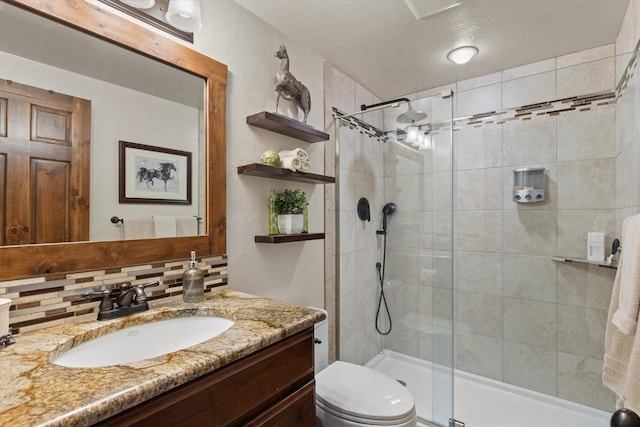 full bathroom with visible vents, backsplash, toilet, a shower stall, and vanity