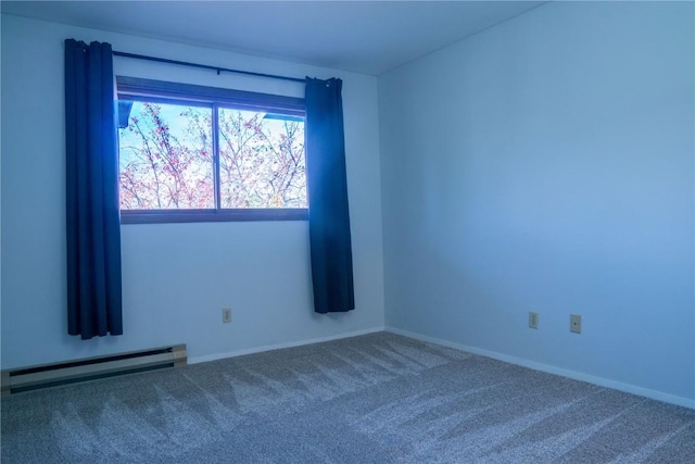 empty room with carpet floors and baseboard heating