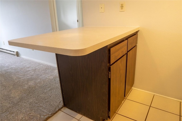 kitchen featuring kitchen peninsula and light carpet