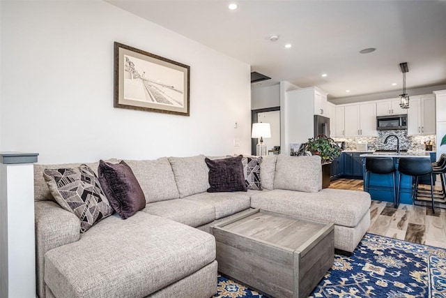 living area with recessed lighting and light wood-type flooring