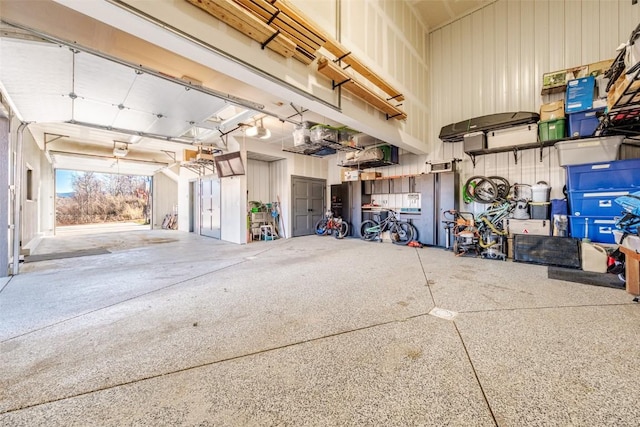 garage with a garage door opener and metal wall