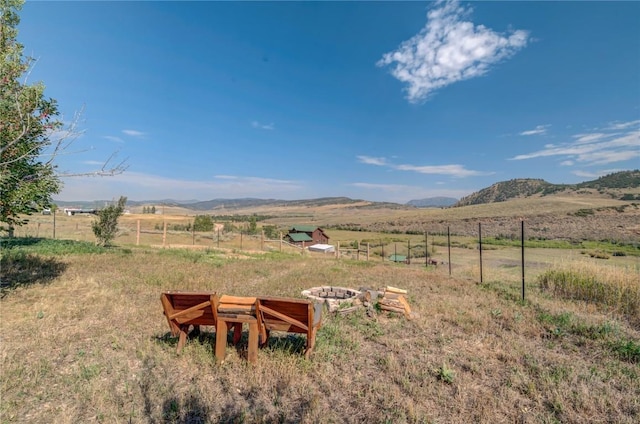 view of yard featuring a rural view and a mountain view