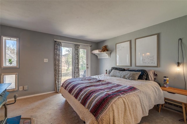 carpeted bedroom with access to exterior, baseboard heating, and baseboards