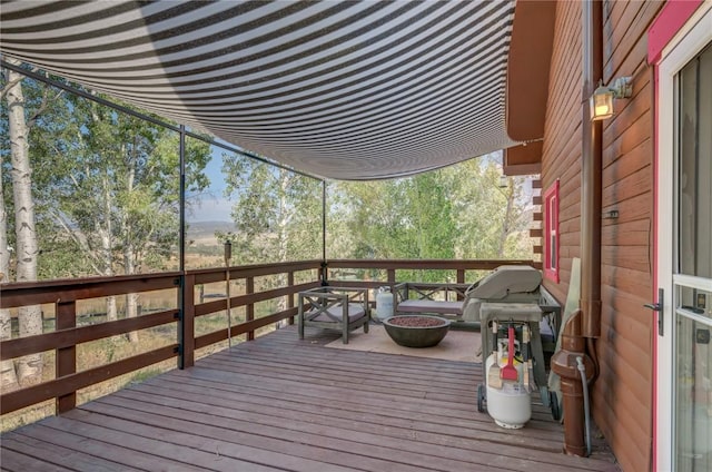 wooden terrace featuring a grill