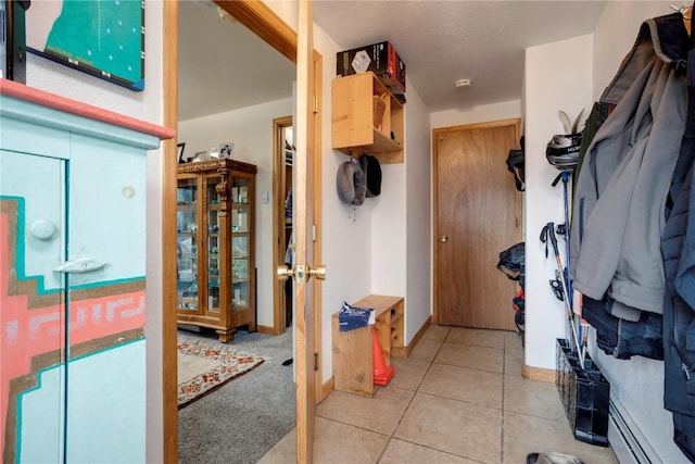 interior space with tile patterned flooring and a baseboard heating unit