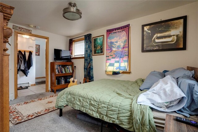 tiled bedroom featuring baseboard heating