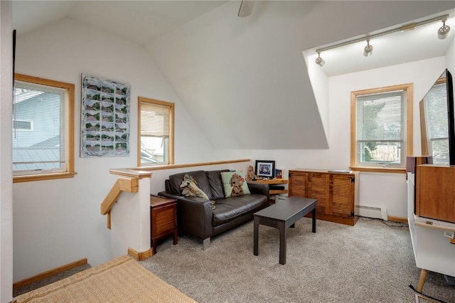 carpeted living room featuring lofted ceiling, track lighting, and baseboard heating