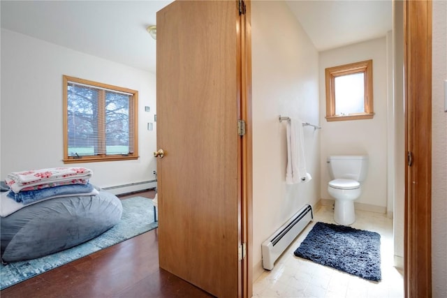 bathroom featuring a baseboard radiator and toilet