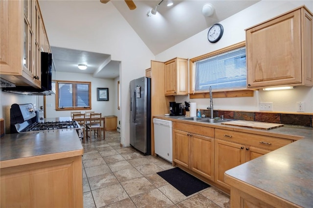 kitchen with vaulted ceiling, sink, stainless steel fridge, range, and white dishwasher