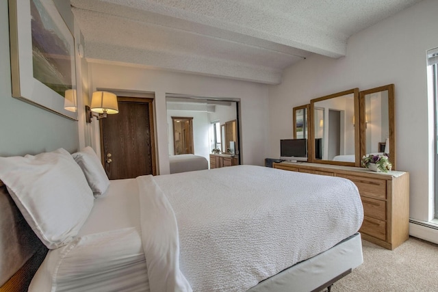 carpeted bedroom featuring beamed ceiling, baseboard heating, and a textured ceiling