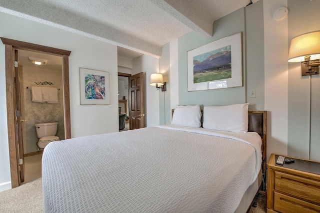 bedroom featuring carpet floors, connected bathroom, and a textured ceiling