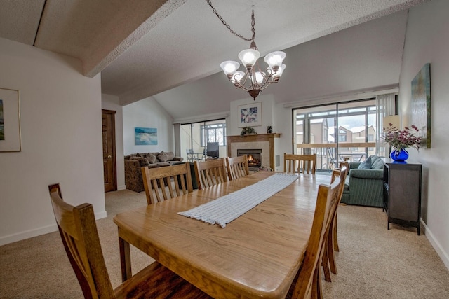 carpeted dining space with a fireplace, a chandelier, lofted ceiling with beams, and a textured ceiling