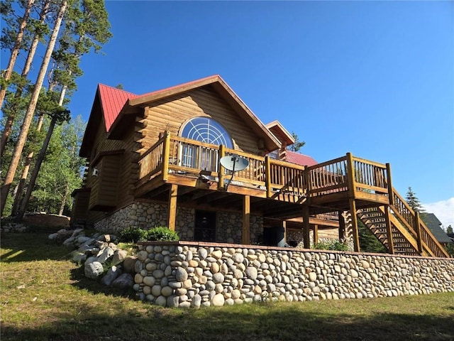 rear view of property with a wooden deck