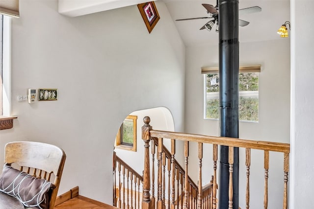 stairs featuring ceiling fan