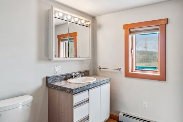 bathroom featuring baseboard heating, vanity, and toilet