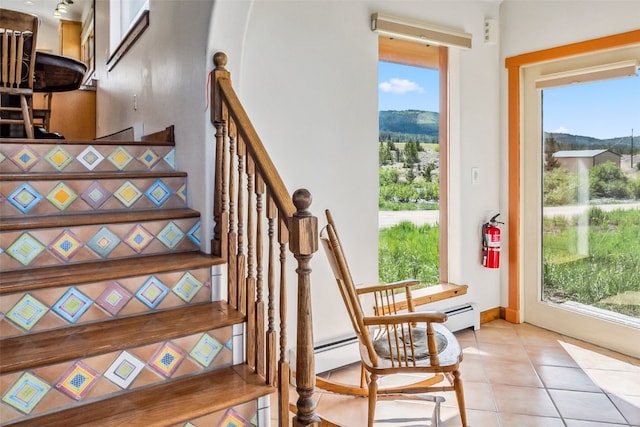 stairs featuring a mountain view, tile patterned floors, and plenty of natural light