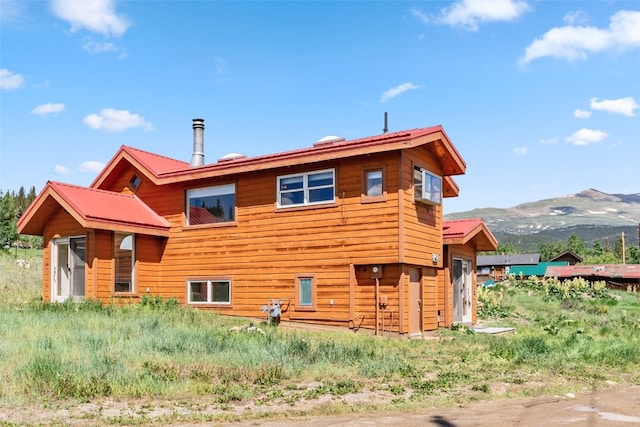 back of property with a mountain view