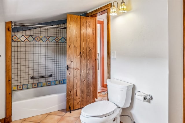 bathroom with toilet, tile patterned floors, and tiled shower / bath