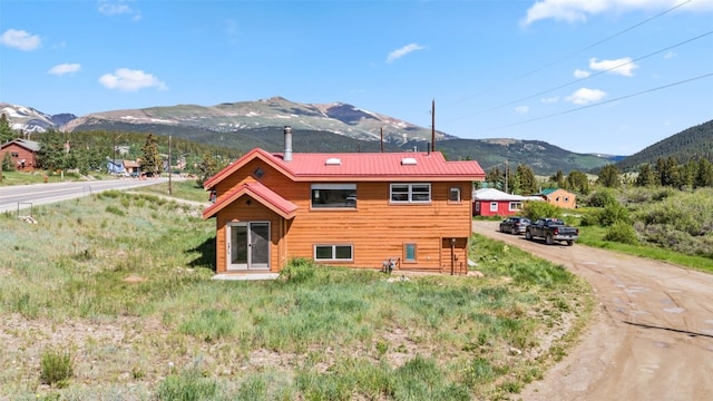 view of side of home with a mountain view