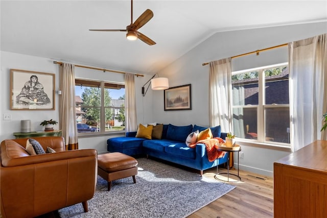 living room with vaulted ceiling, ceiling fan, and light hardwood / wood-style floors