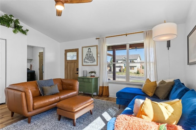 living room featuring hardwood / wood-style flooring and vaulted ceiling