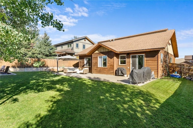 back of property featuring an outdoor living space, a patio, and a lawn