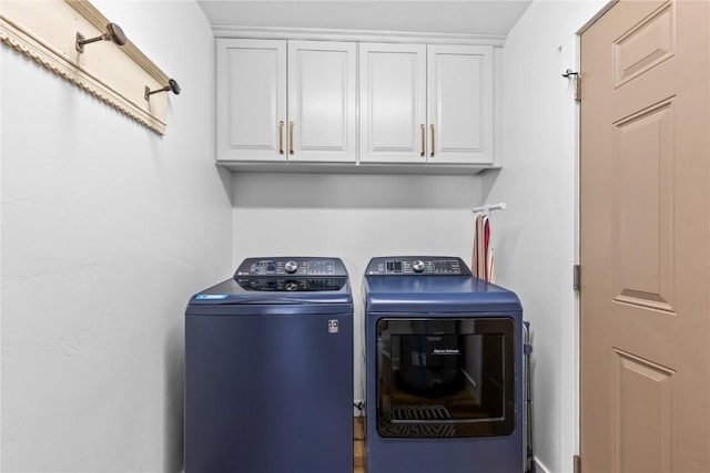 laundry area with cabinets and washing machine and dryer