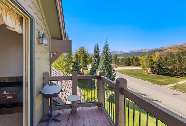 wooden deck featuring a mountain view and grilling area