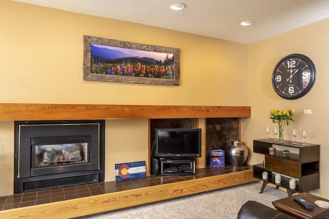 carpeted living room with a textured ceiling