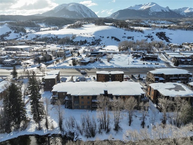 snowy aerial view with a mountain view