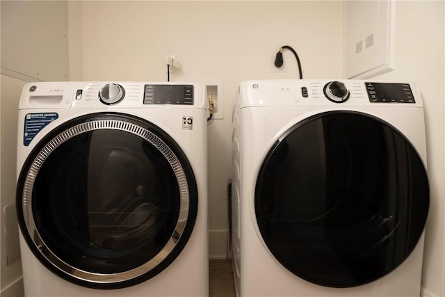 clothes washing area featuring independent washer and dryer