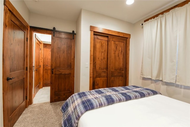 tiled bedroom featuring a barn door