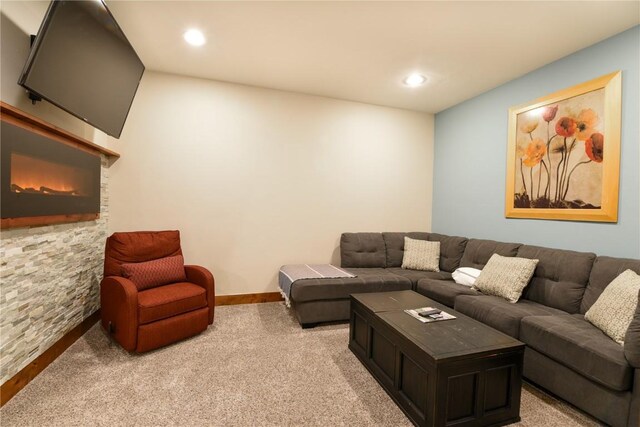 carpeted living room featuring a fireplace