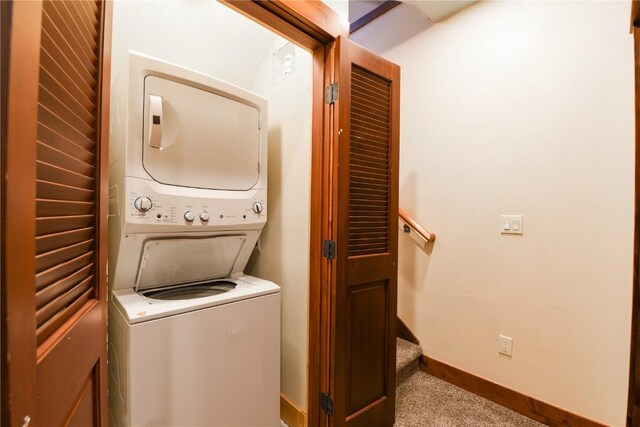 washroom featuring light carpet and stacked washer and clothes dryer