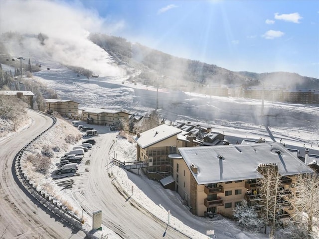 snowy aerial view with a mountain view