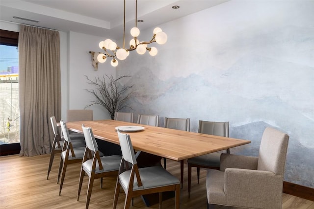 dining room featuring an inviting chandelier and light wood-type flooring