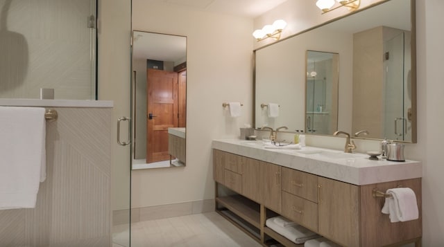 bathroom with vanity, tile patterned floors, and a shower with door