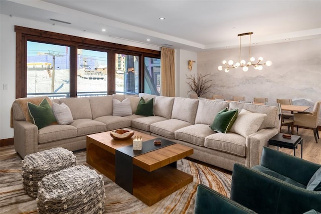 living room featuring an inviting chandelier and wood-type flooring