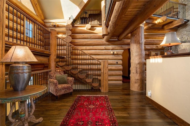 unfurnished room with log walls and dark wood-type flooring