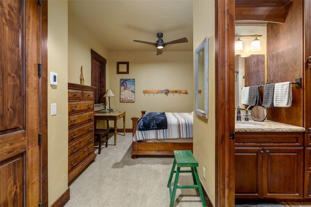 bedroom featuring ceiling fan, sink, and light colored carpet