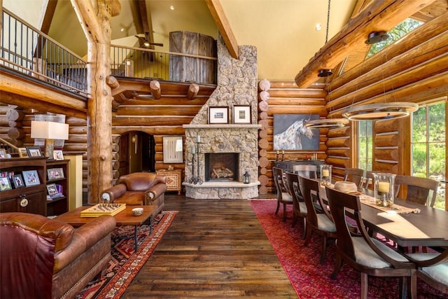 living room featuring a fireplace, high vaulted ceiling, rustic walls, and beamed ceiling