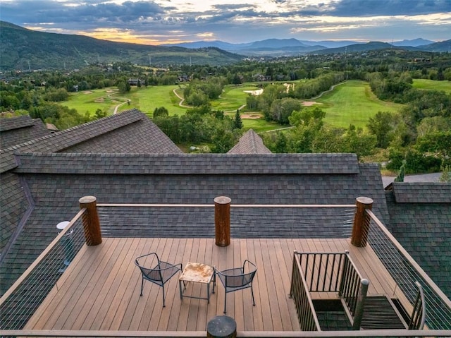 deck at dusk featuring a mountain view