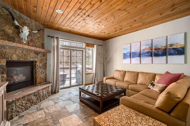 living room featuring wood ceiling and a stone fireplace