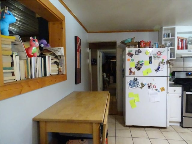 kitchen with white cabinetry, light tile patterned floors, white refrigerator, electric range, and ornamental molding