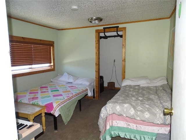 bedroom with ornamental molding, a textured ceiling, and carpet