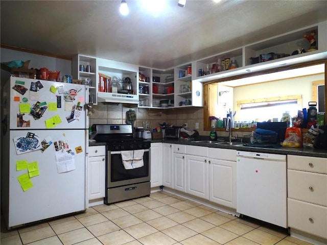 kitchen featuring sink, tasteful backsplash, light tile patterned floors, white appliances, and white cabinets