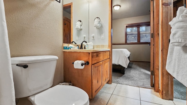 bathroom with vanity, toilet, and tile patterned flooring