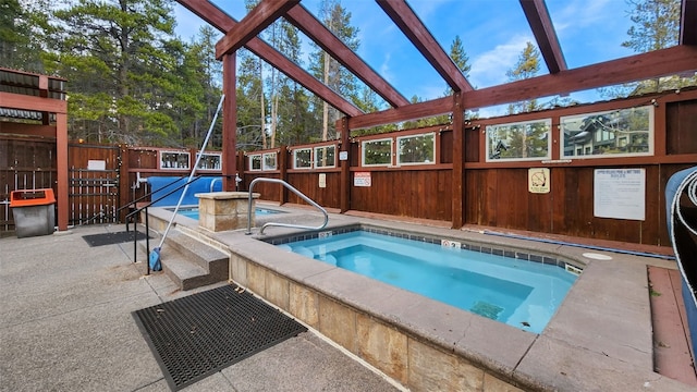 view of swimming pool featuring an indoor hot tub and a patio area