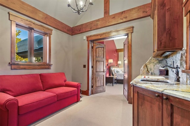 living room with light colored carpet, a notable chandelier, lofted ceiling, and sink