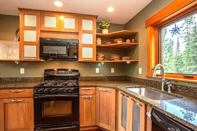 kitchen with sink, black appliances, and dark stone counters